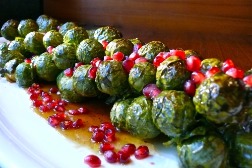 Roasted Brussels sprout stalk with pomegranate seeds